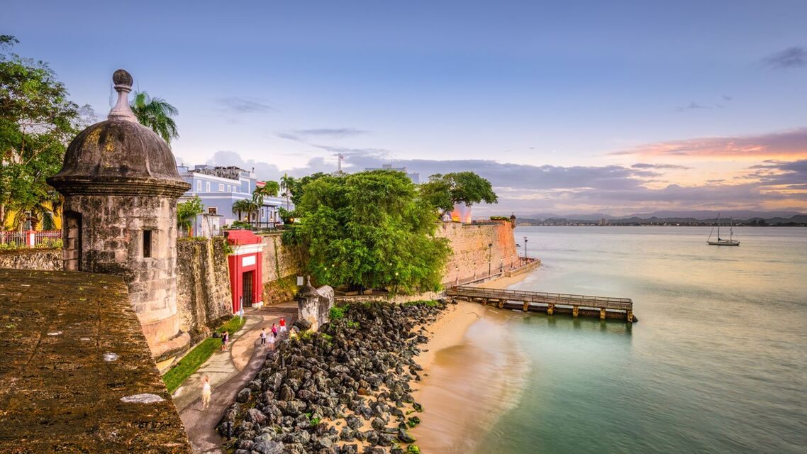 Stone sentry box on the old city wall of San Juan above the bay at dusk